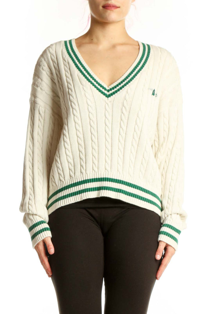 Cream cable knit v-neck pullover sweater with green and white striped trim, front view