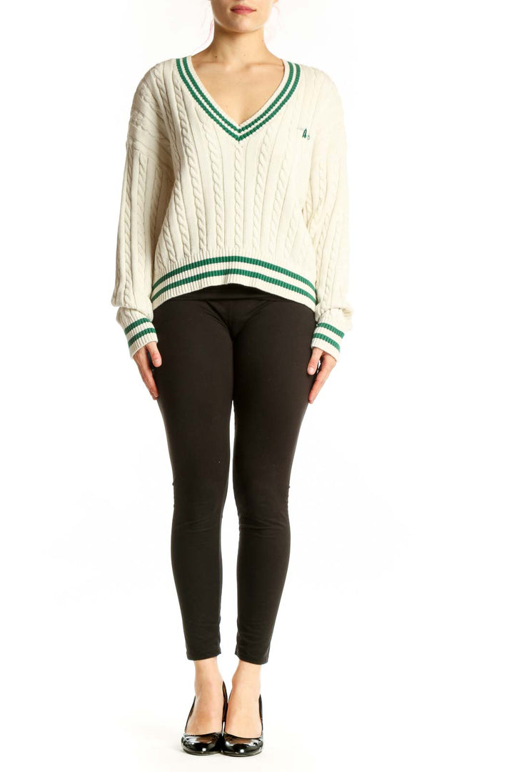 Cream cable knit v-neck pullover sweater with green and white striped trim, front view