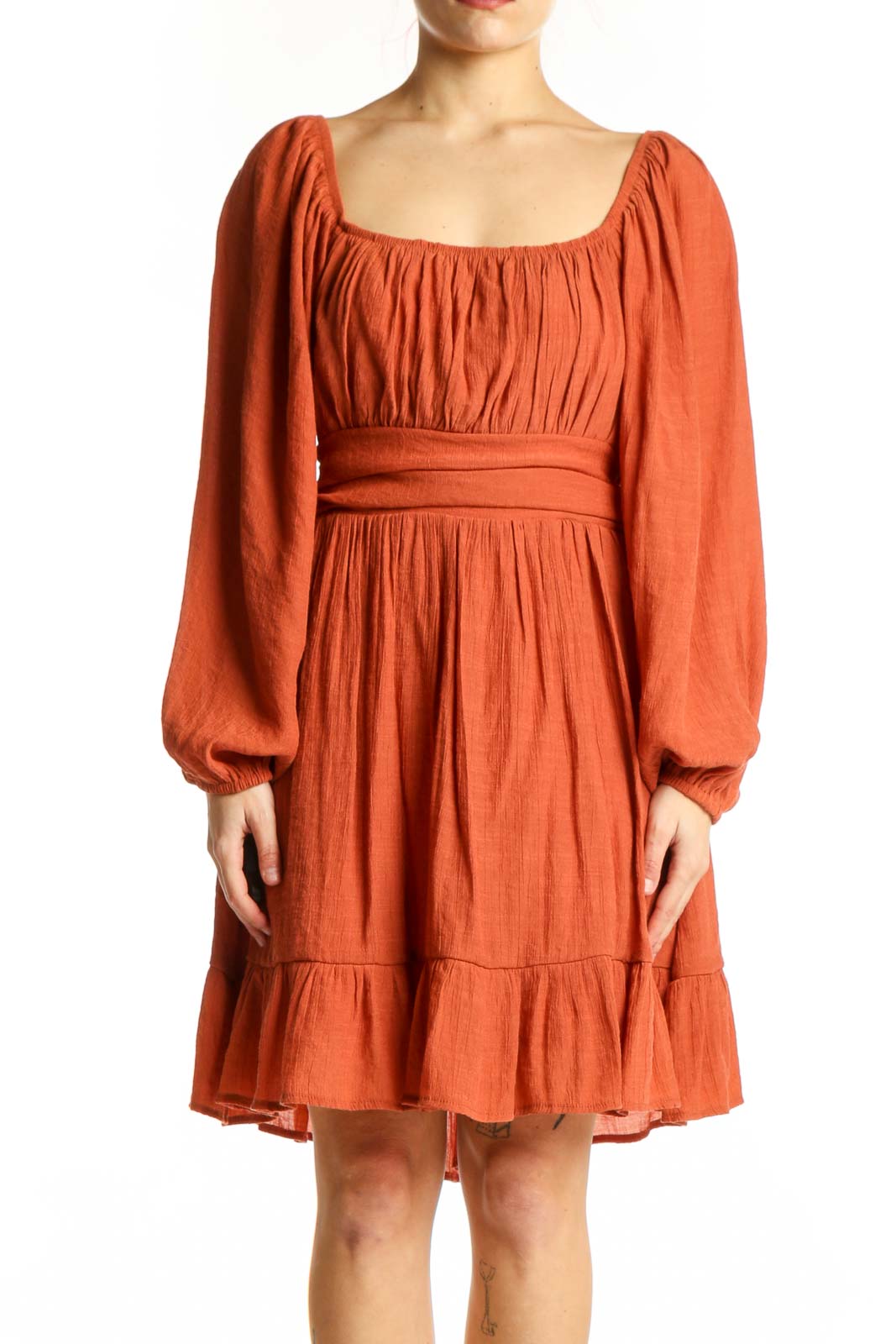 Front view of orange puff sleeve empire waist dress with gathered neckline and tiered ruffle hem