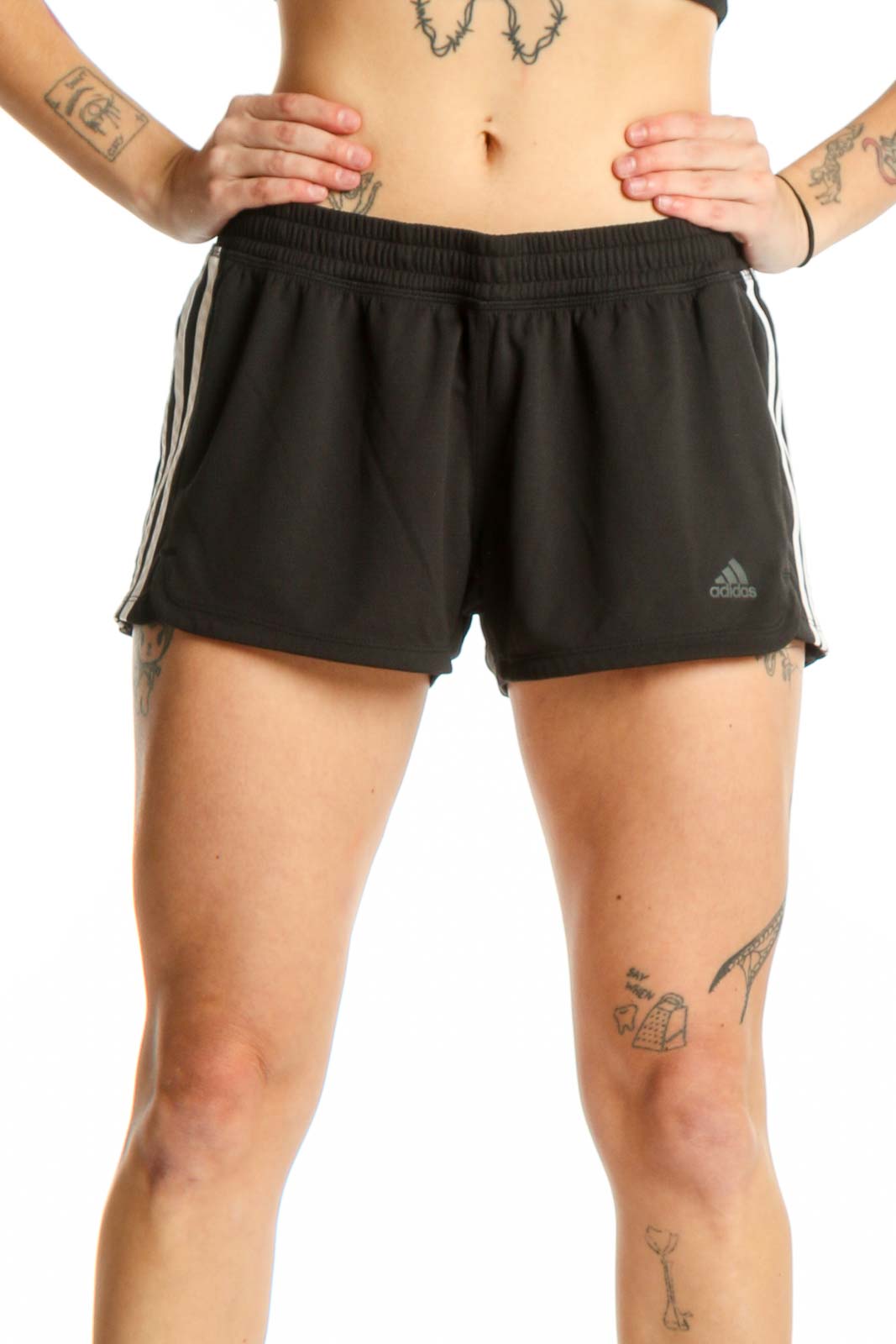 Black Adidas athletic shorts with three-stripe detailing, front view on model