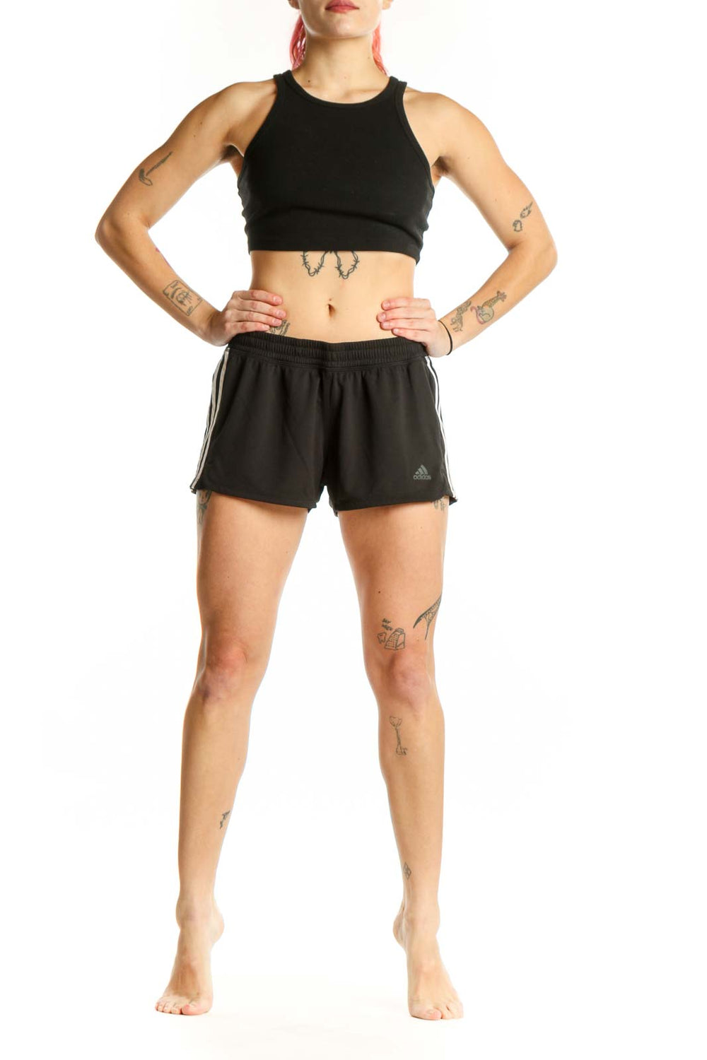Black Adidas athletic shorts with three-stripe detailing, front view on model