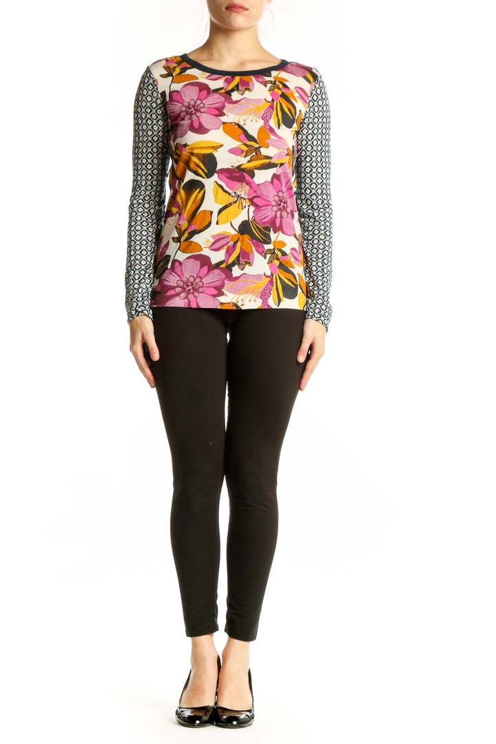 Tory Burch multicolor floral long sleeve top with geometric patterned sleeves, front view on model