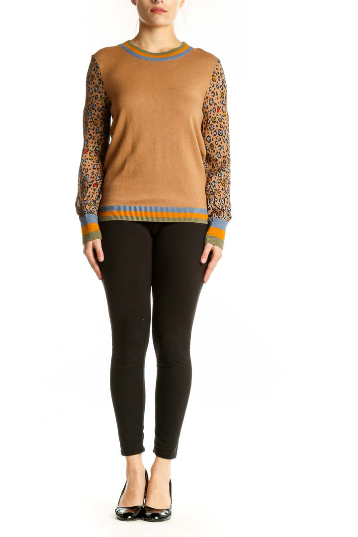 Camel and leopard print colorblock sweater with blue crew neck and orange striped ribbing, front view