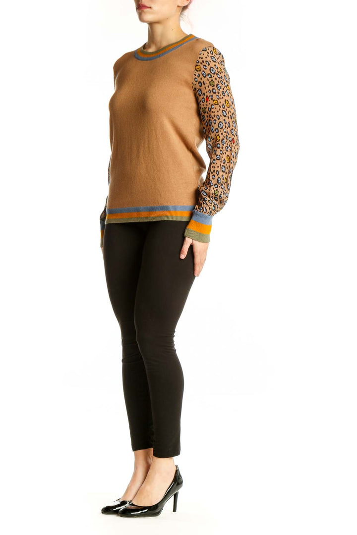Camel and leopard print colorblock sweater with blue crew neck and orange striped ribbing, front view