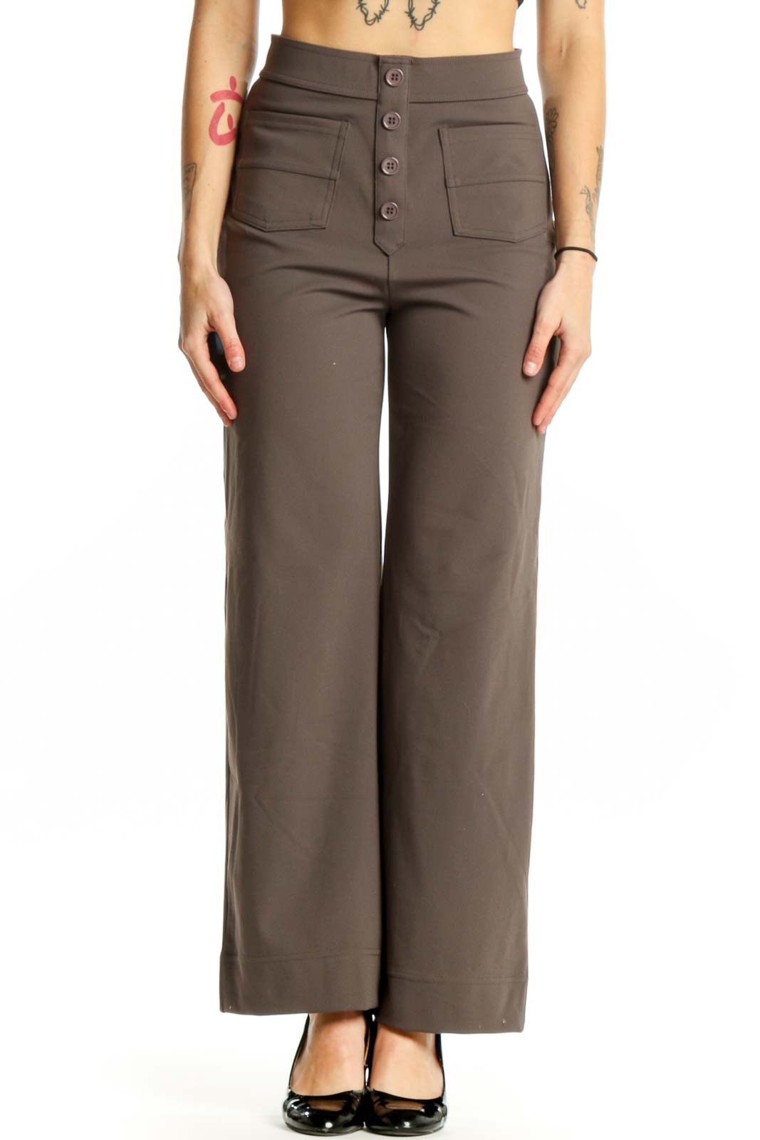 Brown high-waisted button-front pants with functional pockets, front view on model