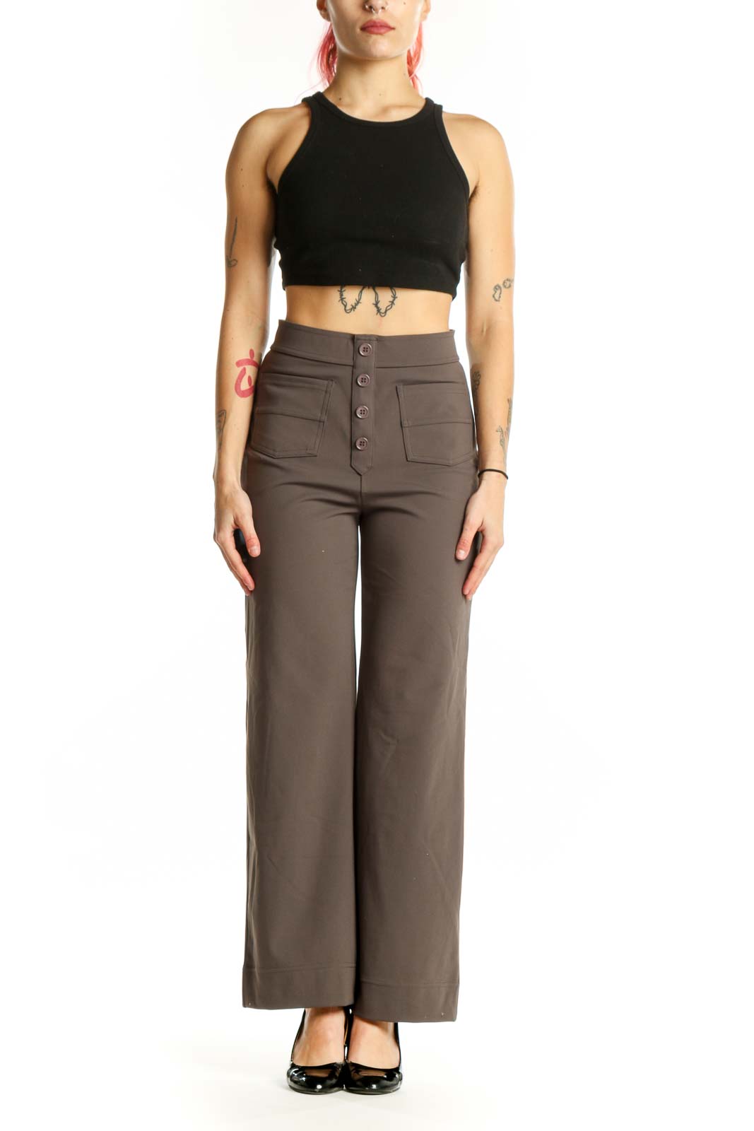 Brown high-waisted button-front pants with functional pockets, front view on model