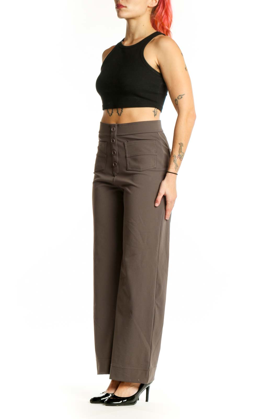Brown high-waisted button-front pants with functional pockets, front view on model