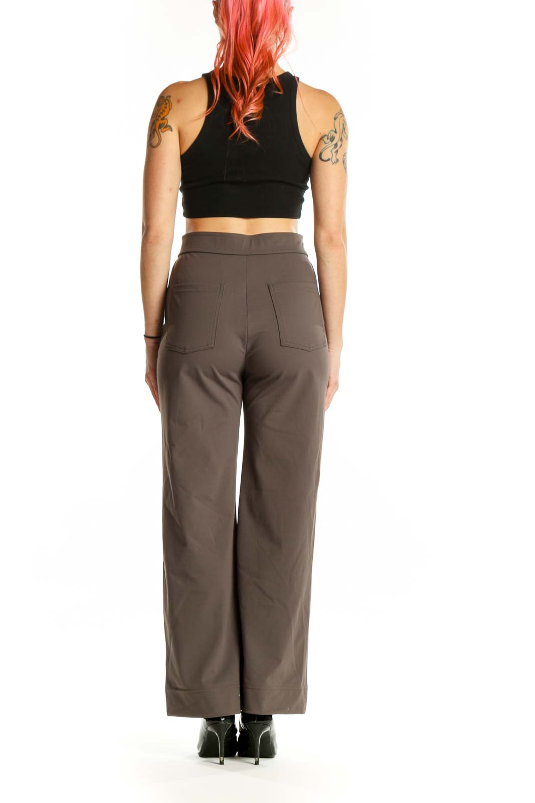 Brown high-waisted button-front pants with button closure detail, back view on model