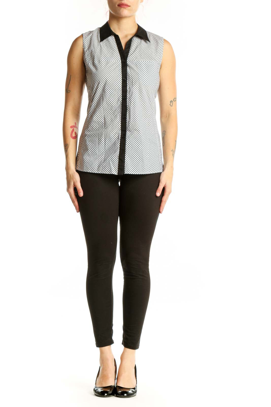 White diagonal striped sleeveless button-up top with black collar trim and contrasting black front placket, front view