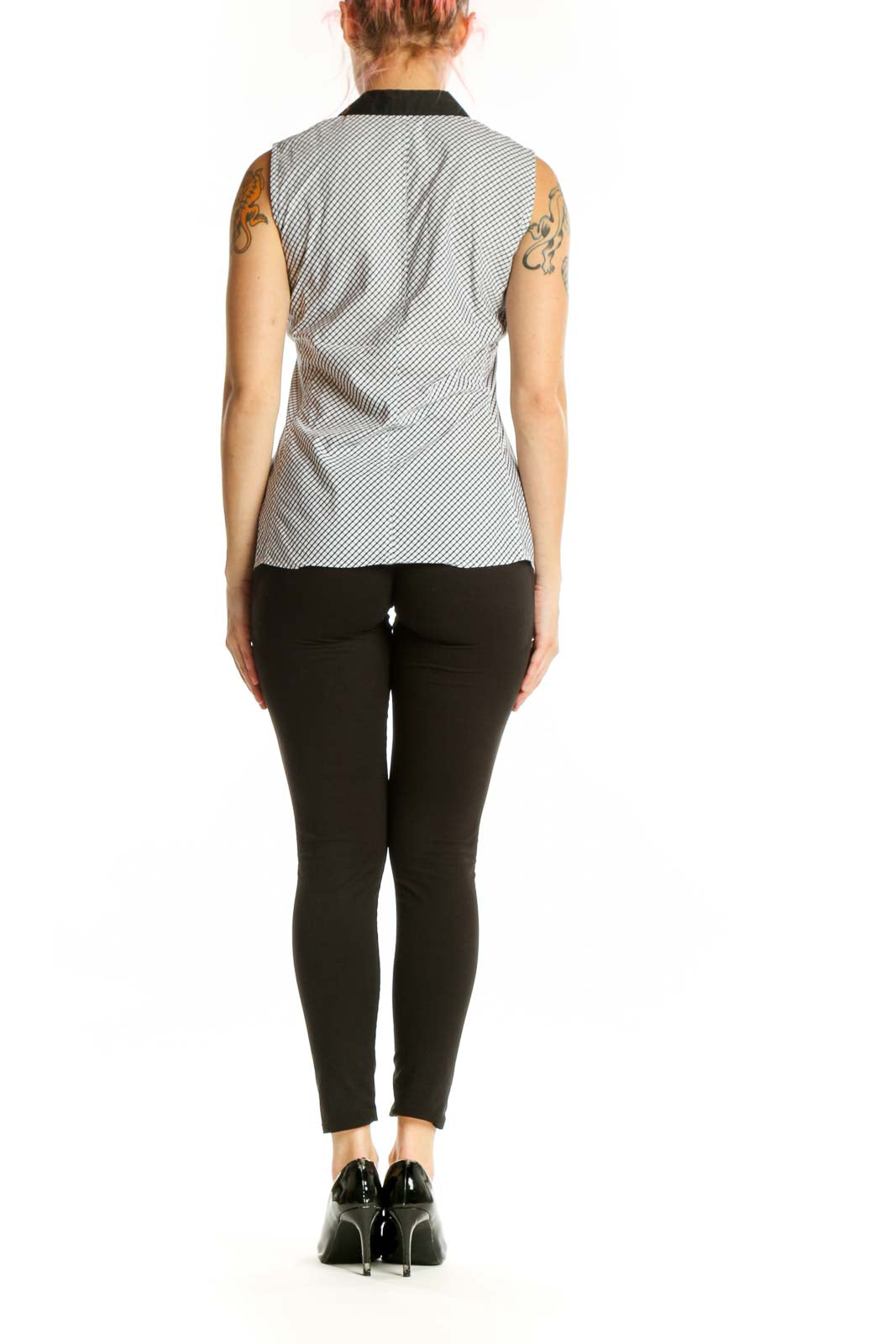 White diagonal striped sleeveless button-up top with black collar trim, back view showing structured fit