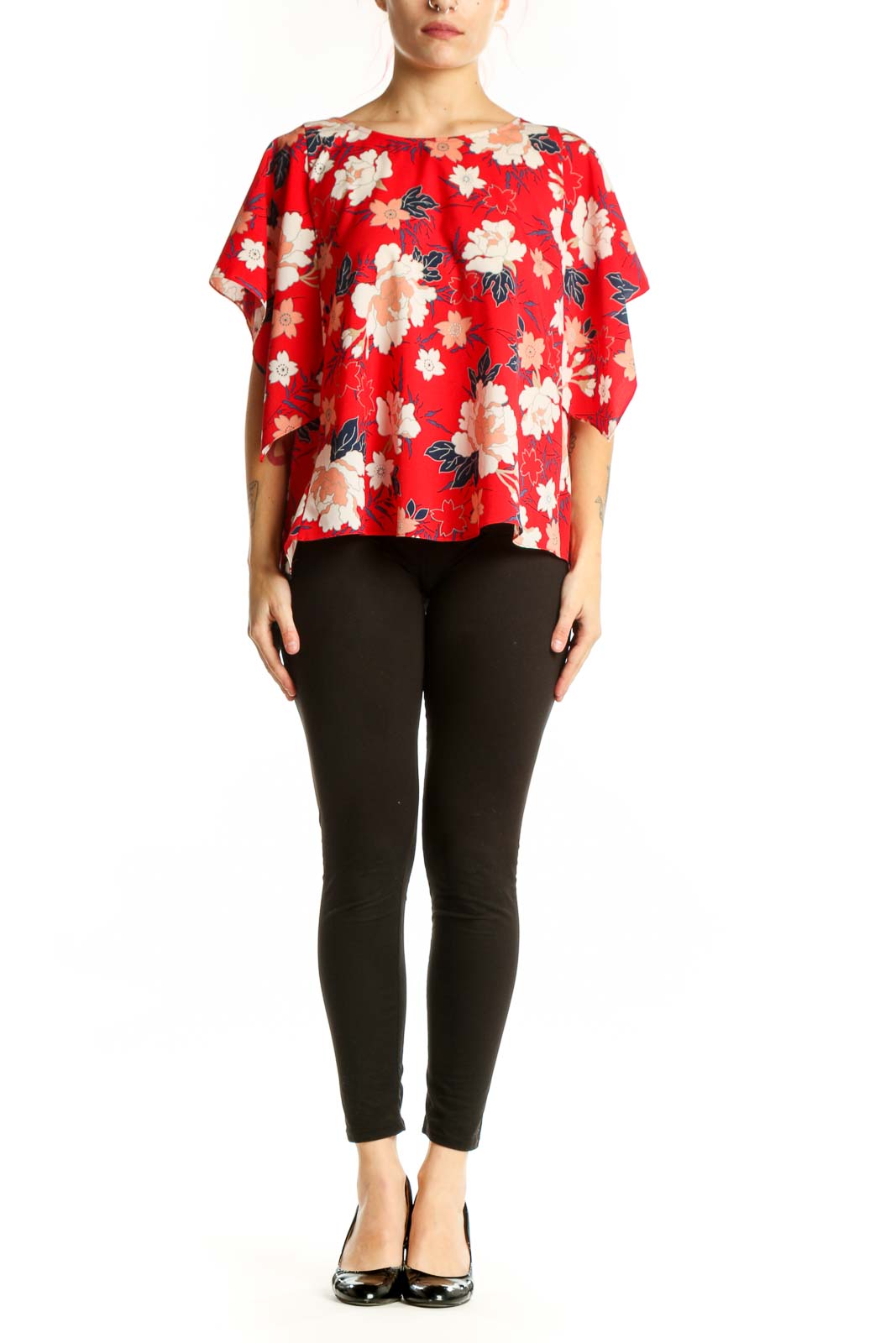 Red floral short sleeve blouse with cream and peach flowers, worn with black leggings