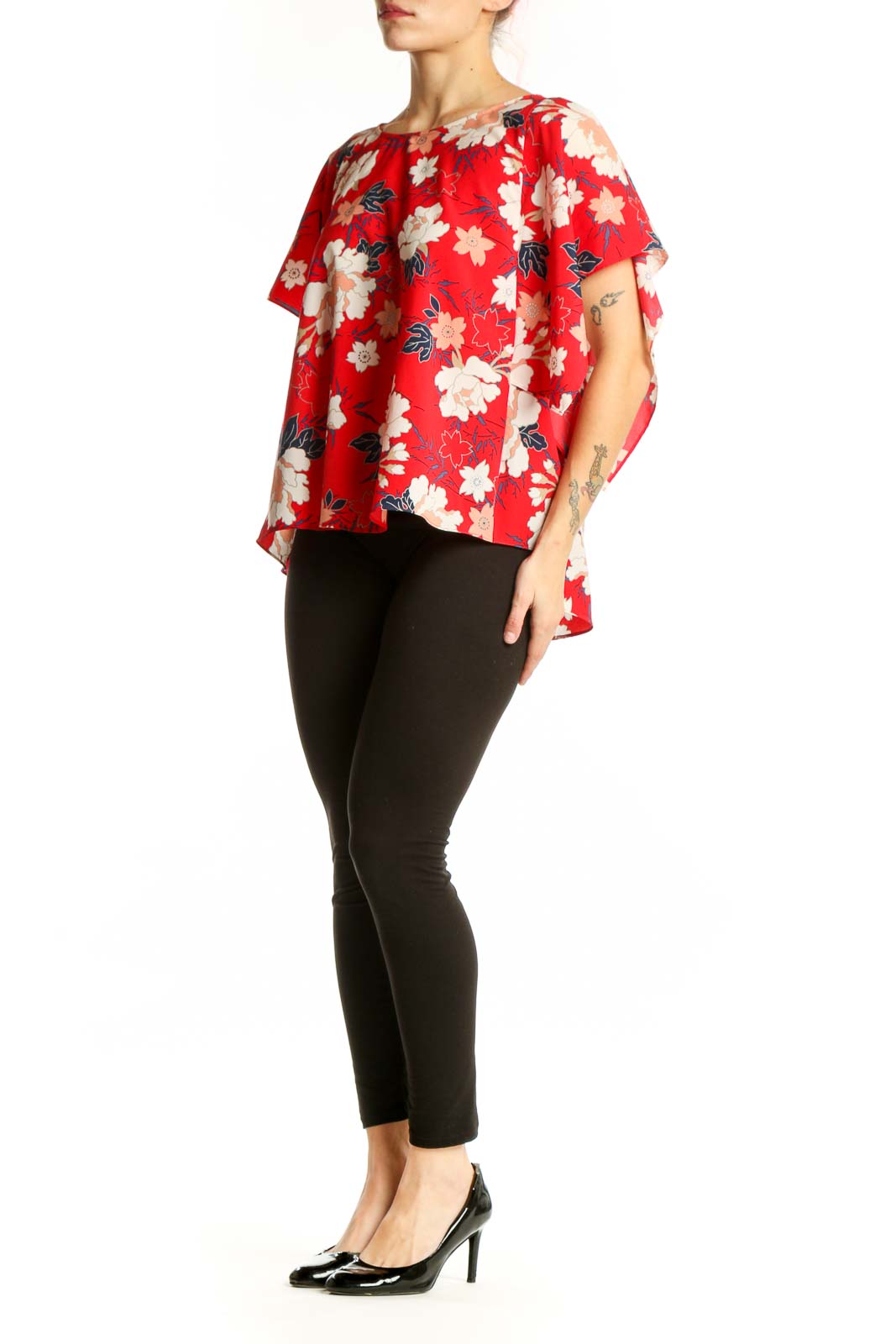 Red floral short sleeve blouse with cream and peach flowers, worn with black leggings