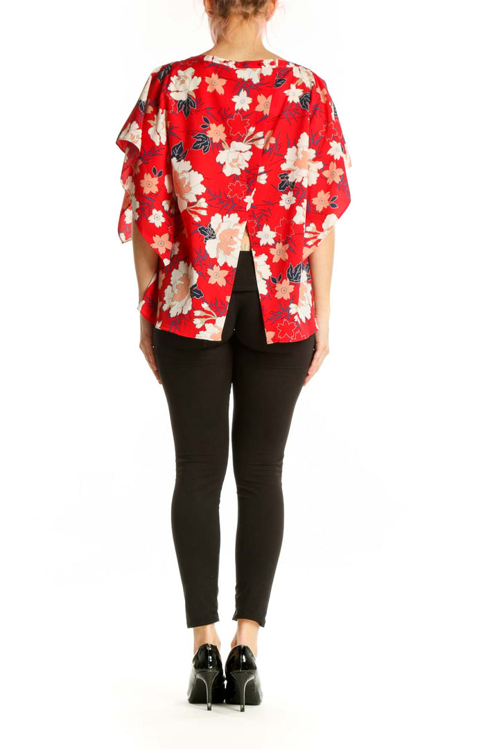 Back view of red floral blouse showing asymmetrical hem and relaxed oversized fit