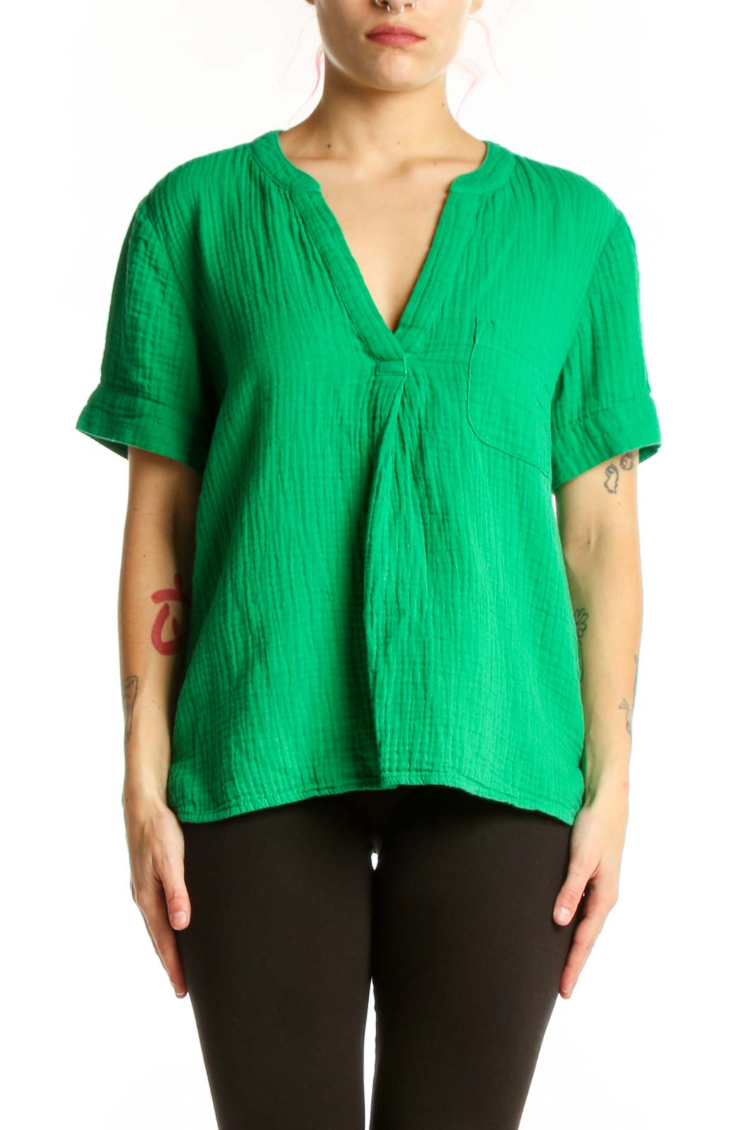 Woman wearing vibrant green V-neck cotton short sleeve top with relaxed fit