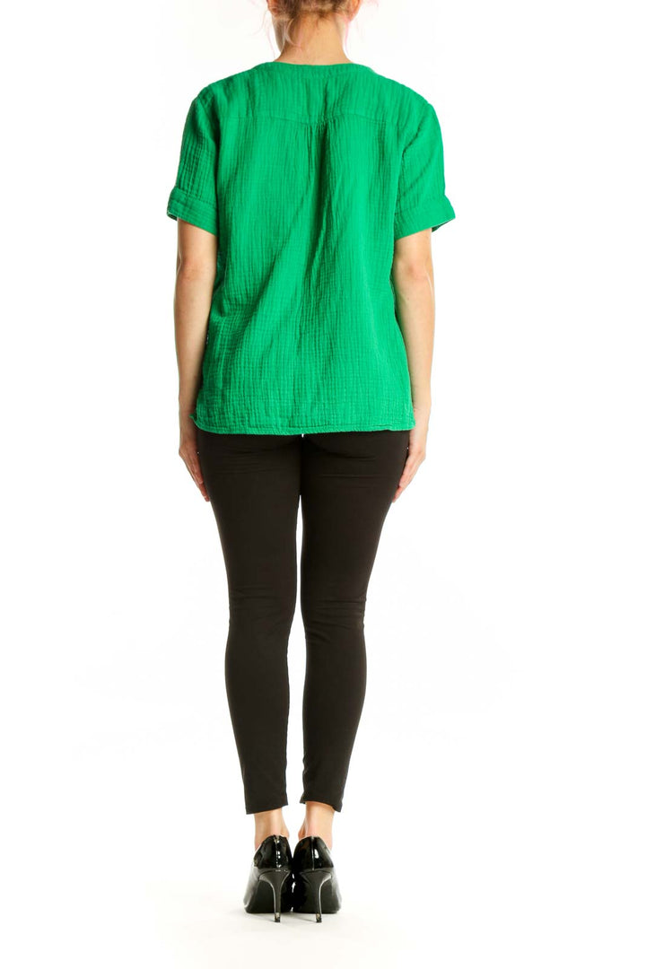 Back view of green V-neck cotton short sleeve top showing relaxed silhouette