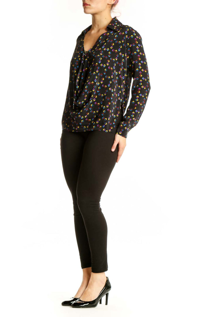 Black silk blouse with multicolor floral print, button-front closure and tie neckline detail by Derek Lam