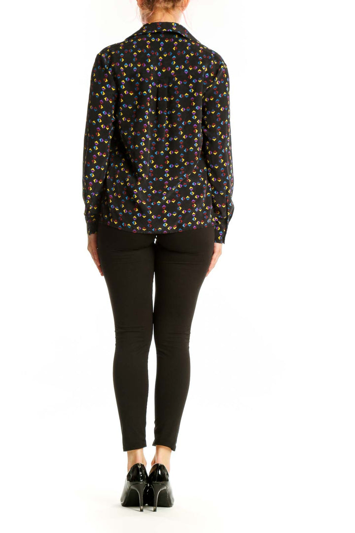Back view of black Derek Lam silk blouse showing floral print pattern and relaxed fit silhouette