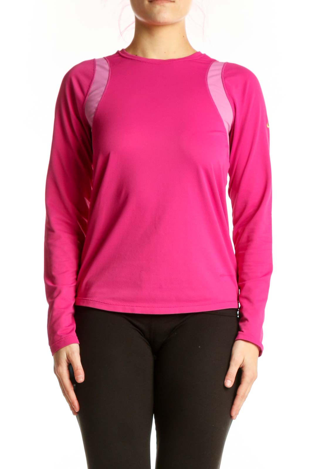 Front view of pink Nike long sleeve athletic top with mesh shoulder panels on model, paired with black leggings