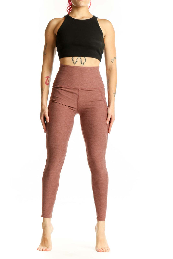 Beyond Yoga mauve high-waist cropped leggings front view showing fitted silhouette and textured fabric