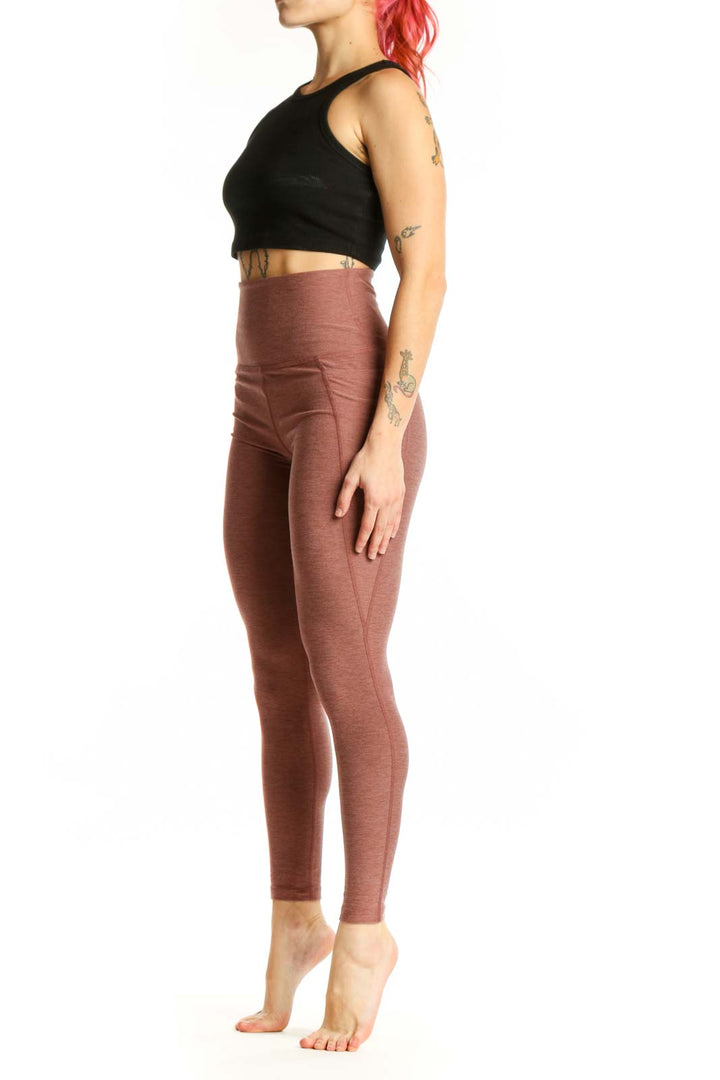 Beyond Yoga mauve high-waist cropped leggings front view showing fitted silhouette and textured fabric