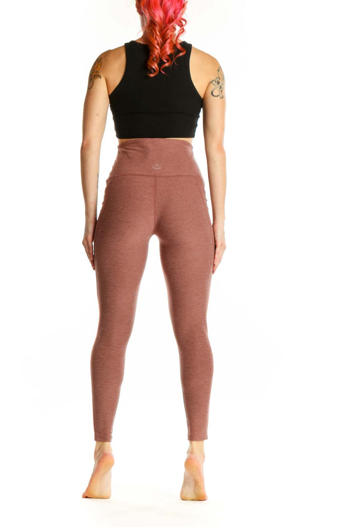 Beyond Yoga mauve high-waist cropped leggings back view displaying high-waist design and cropped length