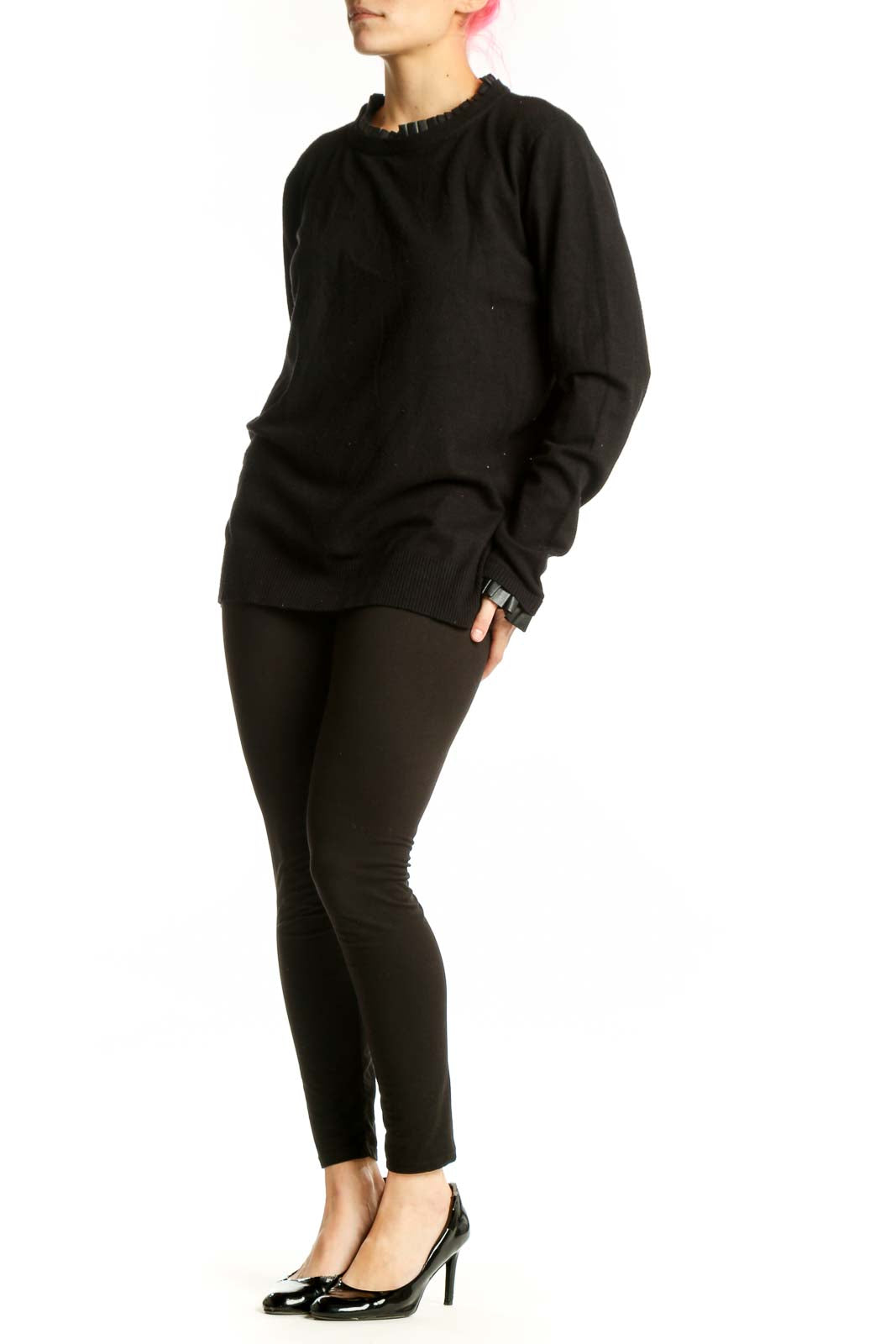 Black knit sweater with ruffle trim neckline and cuffs, front view on model