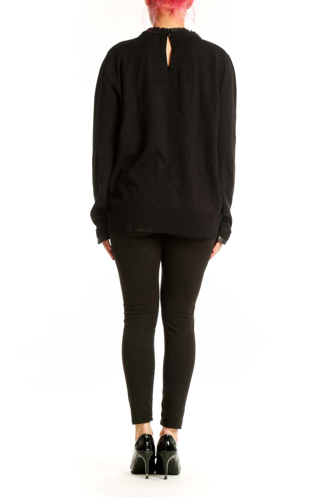 Black knit sweater back view showing relaxed fit and long sleeves on model