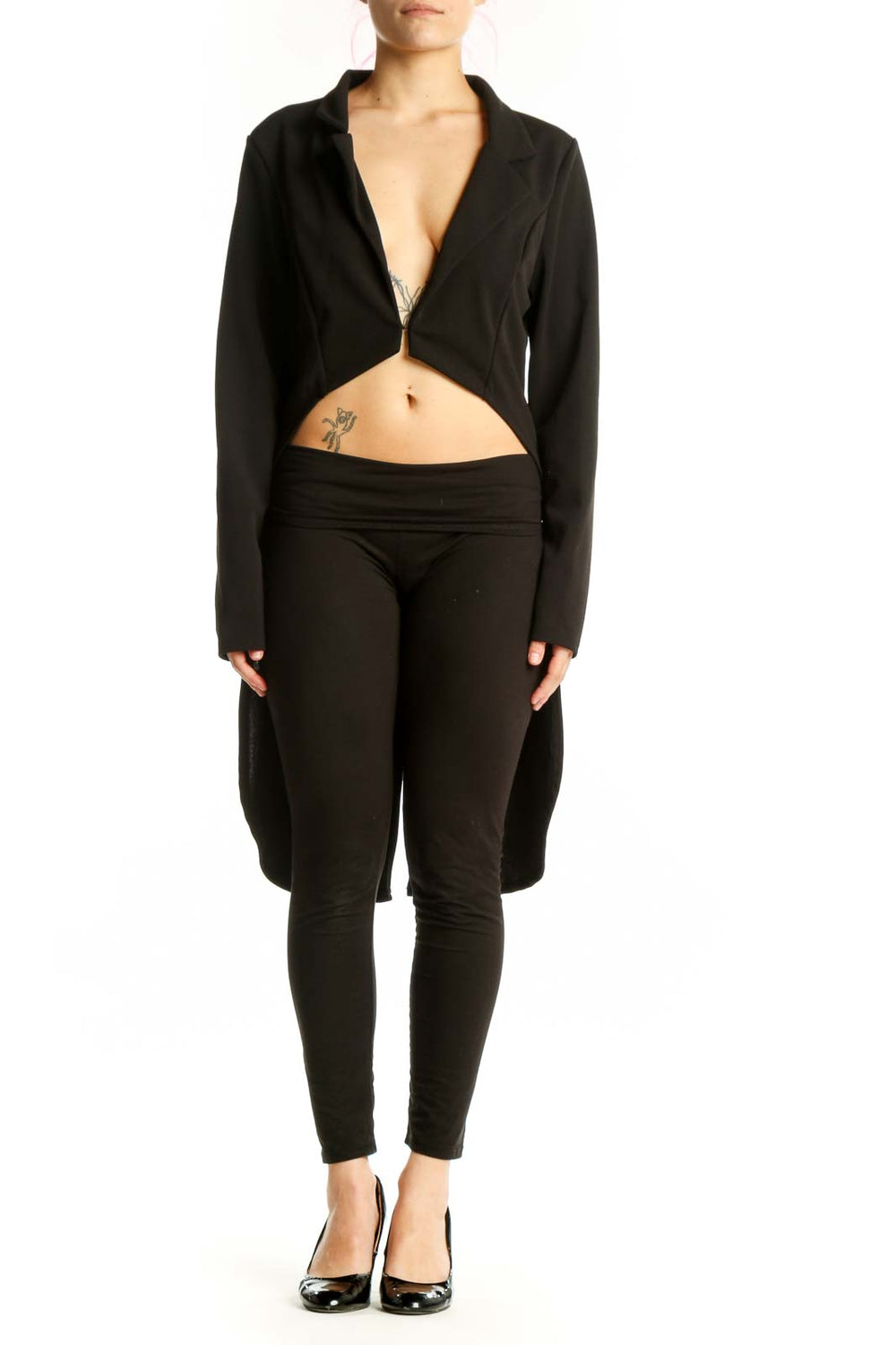 Black cropped blazer jacket with open-front design and midriff cutout, worn with black pants