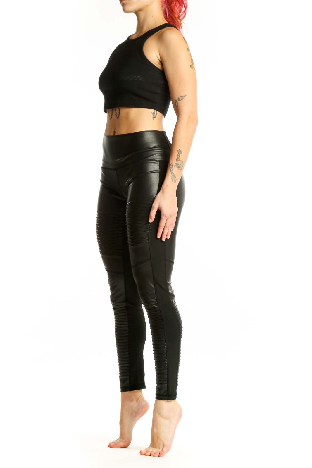 Black ruched faux leather leggings front view, high-waisted design with textured pattern