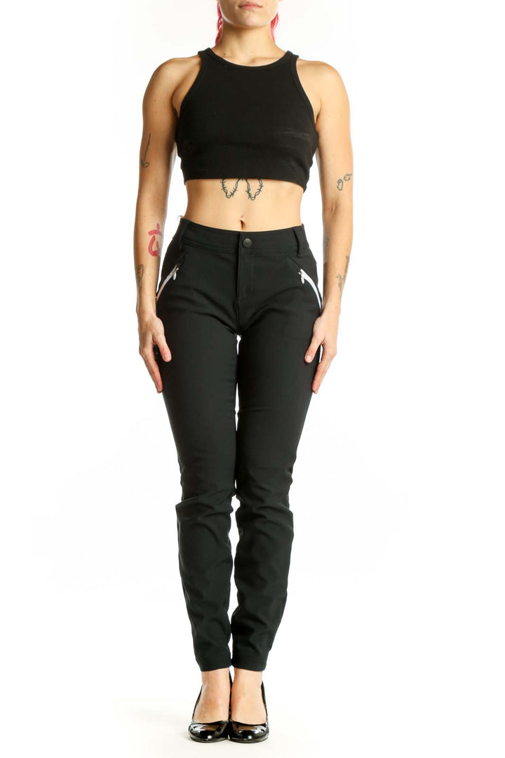 Black slim fit athletic pants front view showing tailored silhouette with side zip pockets and high waistband