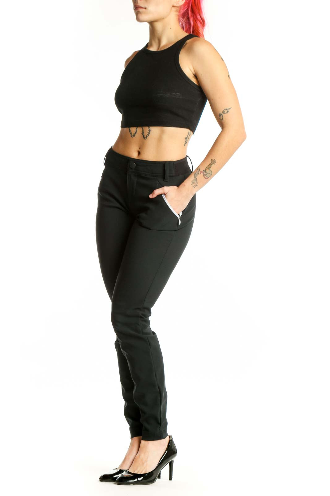 Black slim fit athletic pants front view showing tailored silhouette with side zip pockets and high waistband
