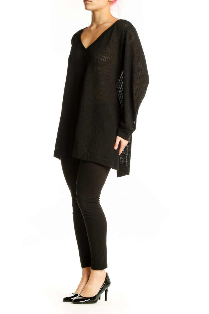 Black waffle knit v-neck tunic with oversized fit and long sleeves, front view
