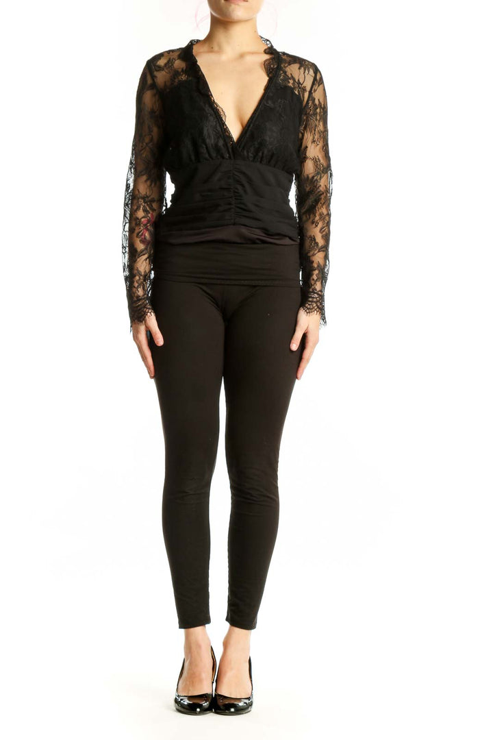 Black lace long sleeve wrap top with V-neckline and ruched waist detail, front view