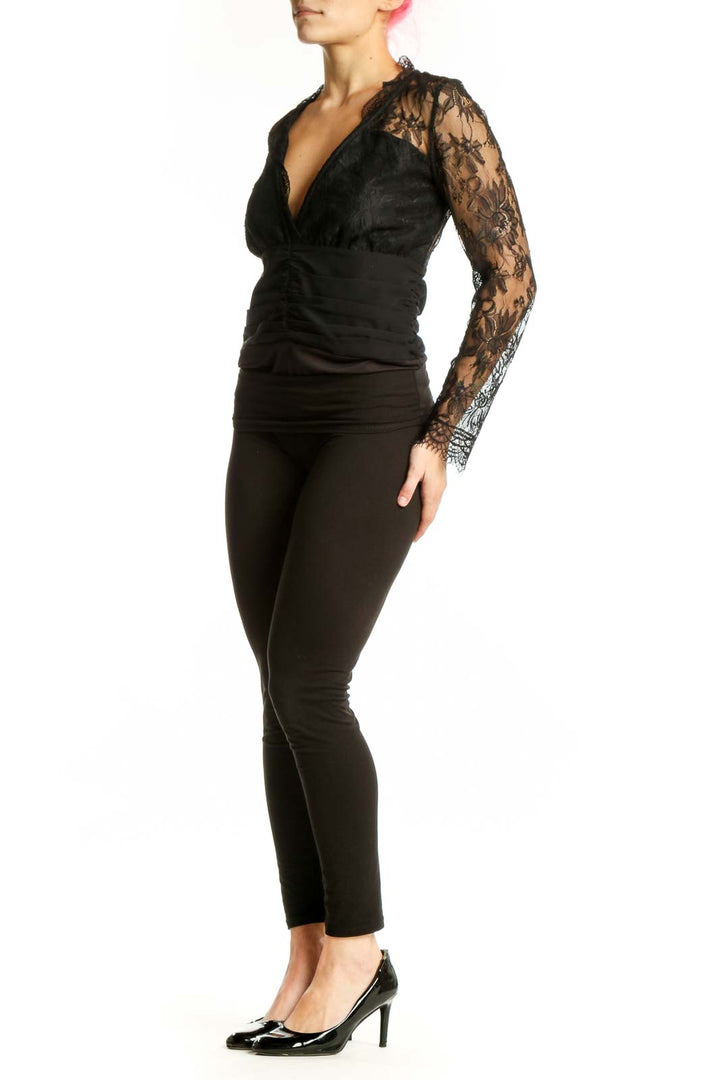Black lace long sleeve wrap top with V-neckline and ruched waist detail, front view