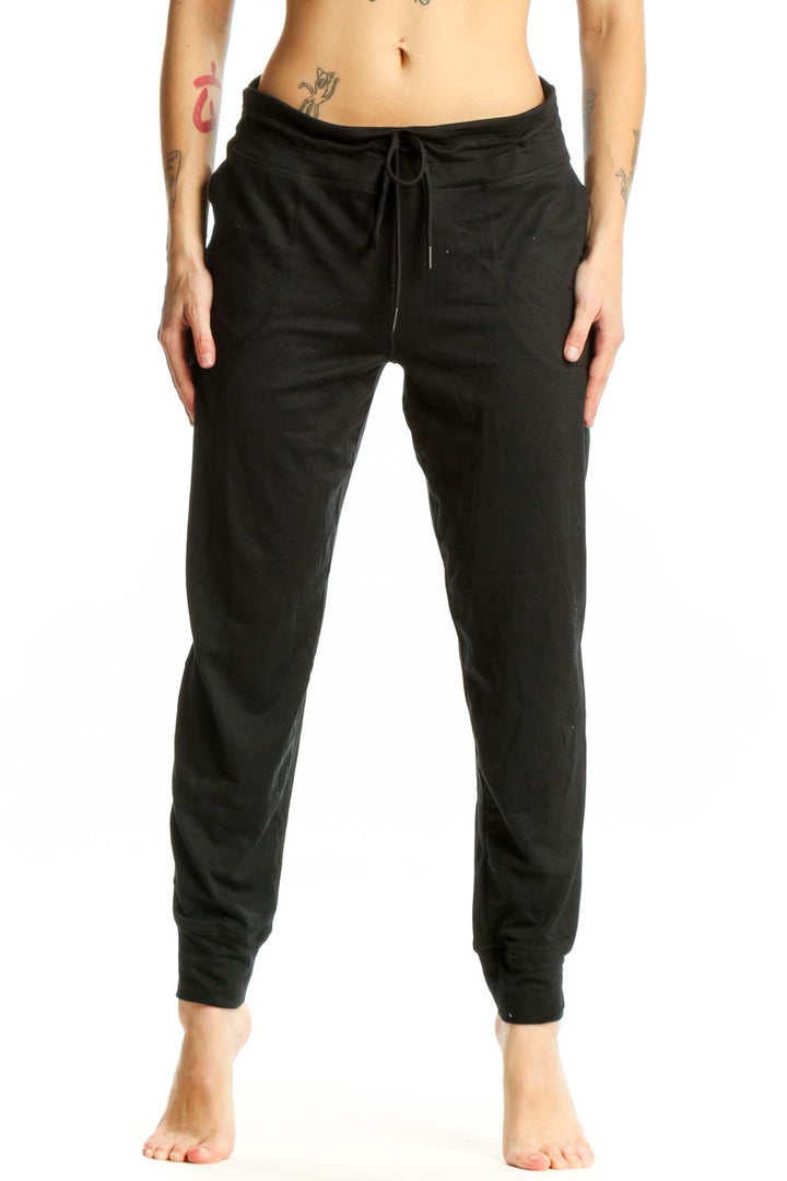 LOLE black jogger pants with drawstring waist and side pockets, front view on model