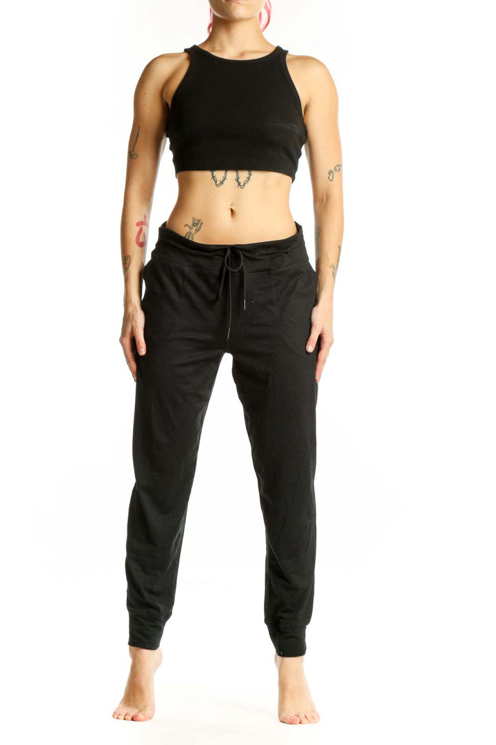 LOLE black jogger pants with drawstring waist and side pockets, front view on model