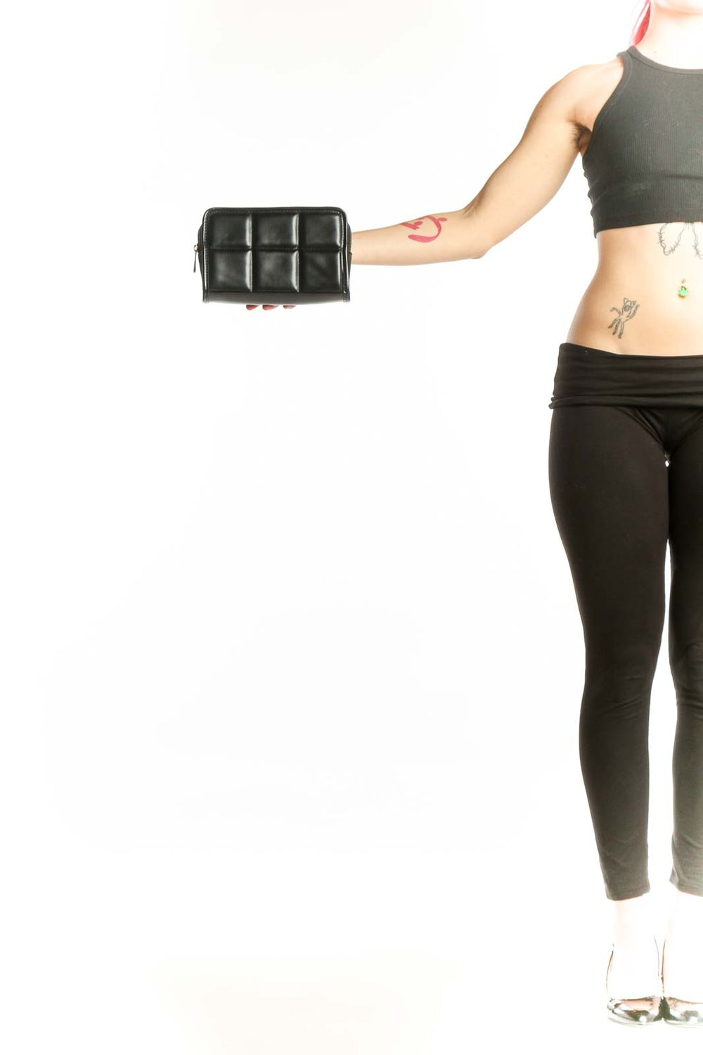 Black quilted crossbody bag with 3x3 grid pattern and zip closure by Amanda Uprichard