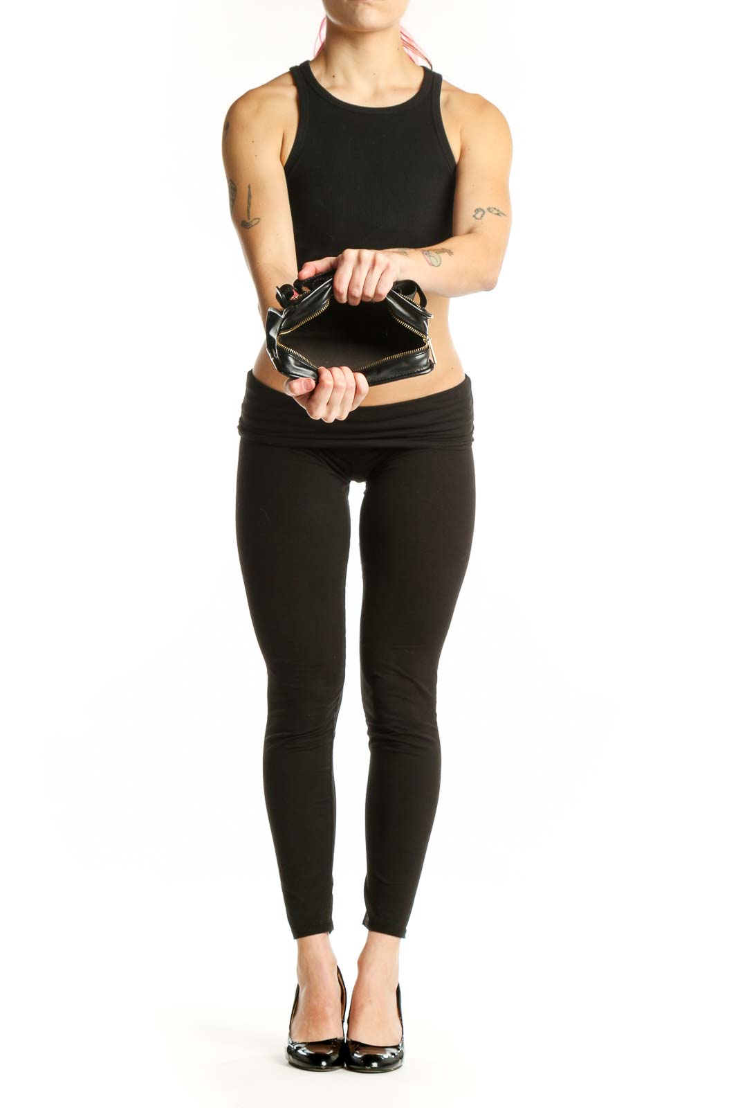 Woman wearing black quilted crossbody bag with adjustable strap across body