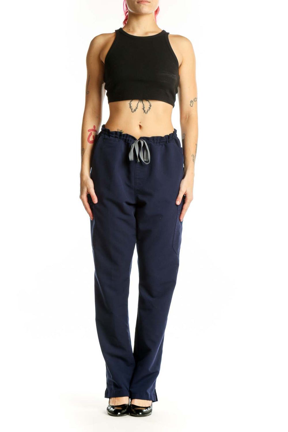 Navy drawstring scrub pants with side pockets, front view on model