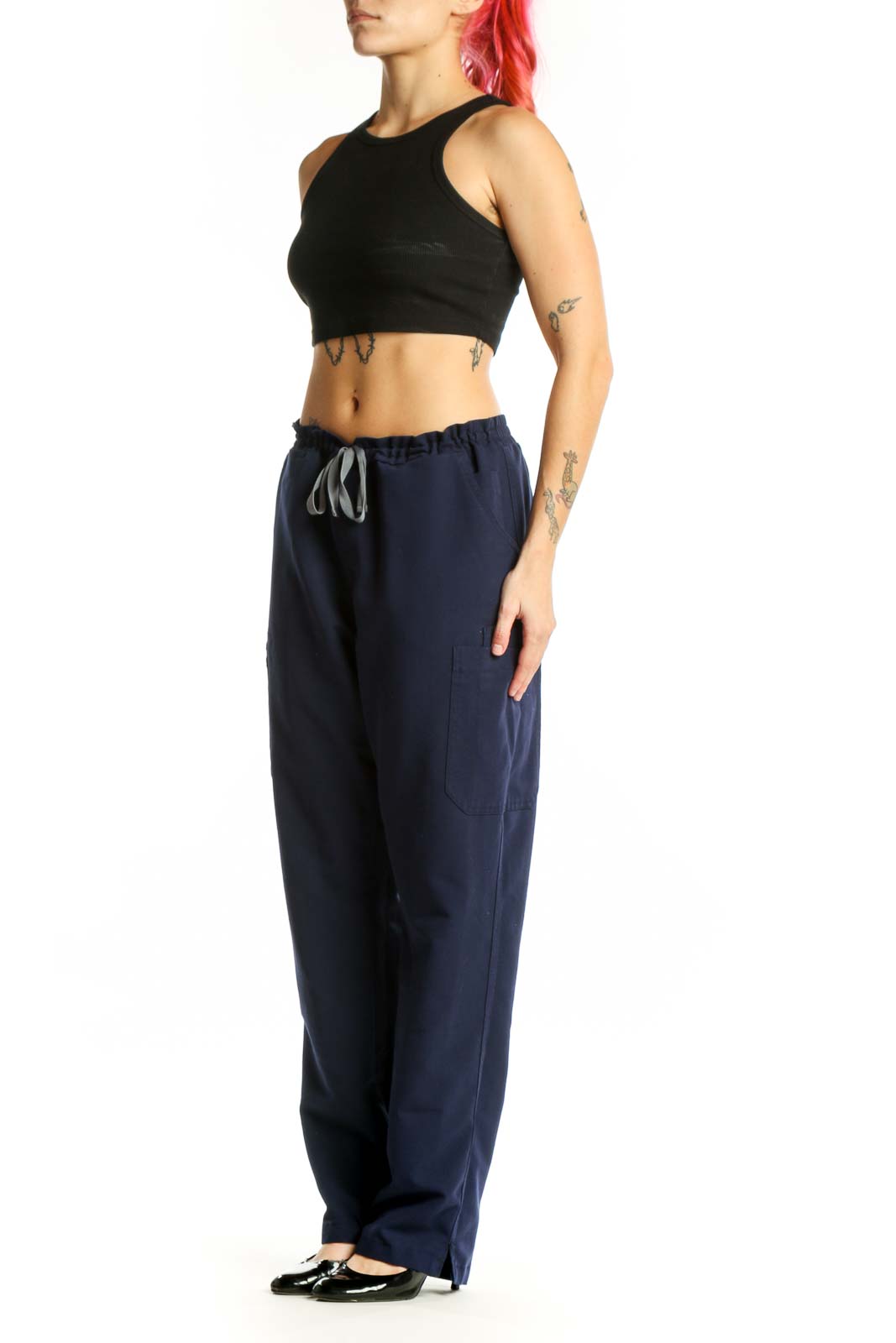 Navy drawstring scrub pants with side pockets, front view on model