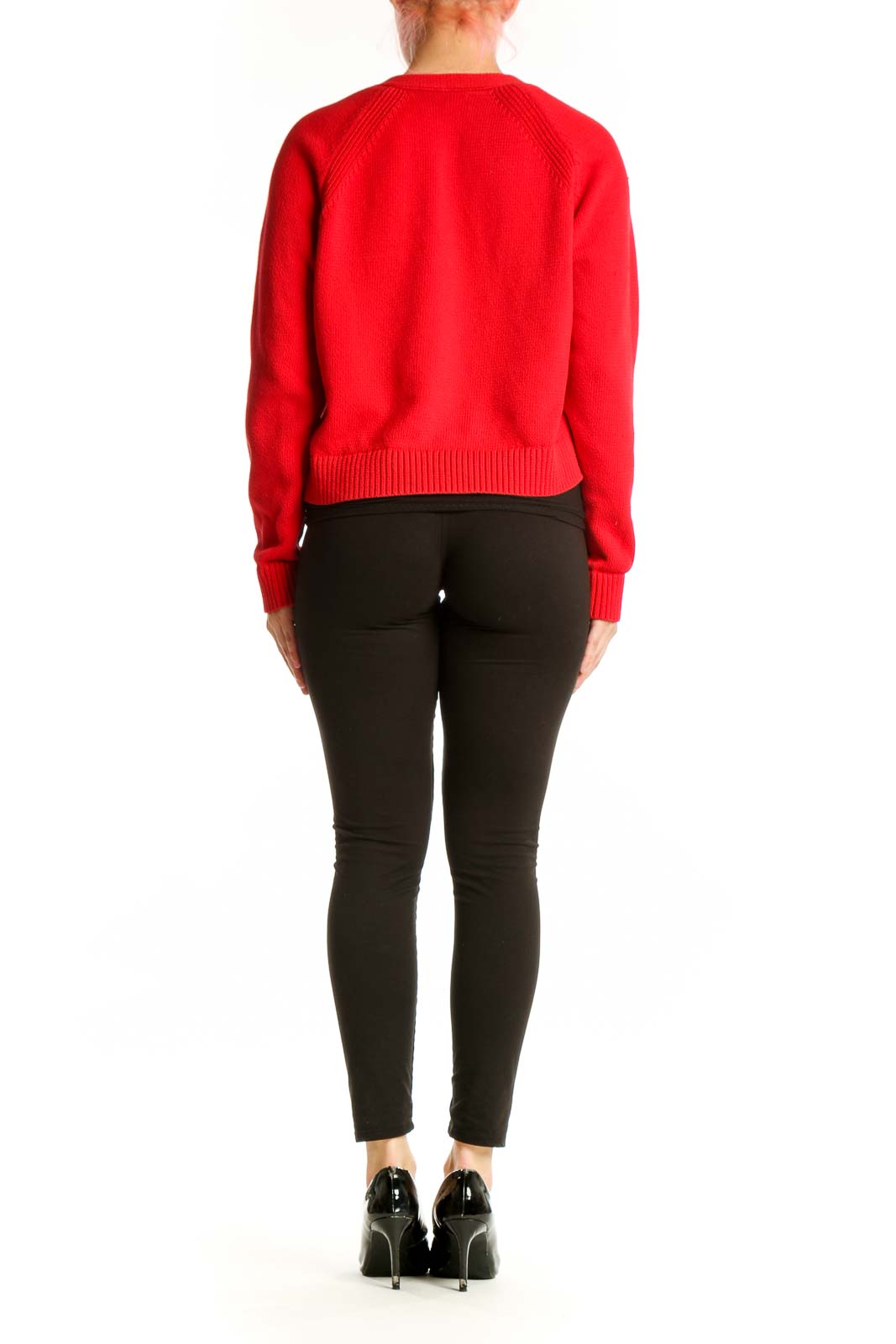 Back view of red cropped cardigan showing ribbed knit construction and fitted silhouette