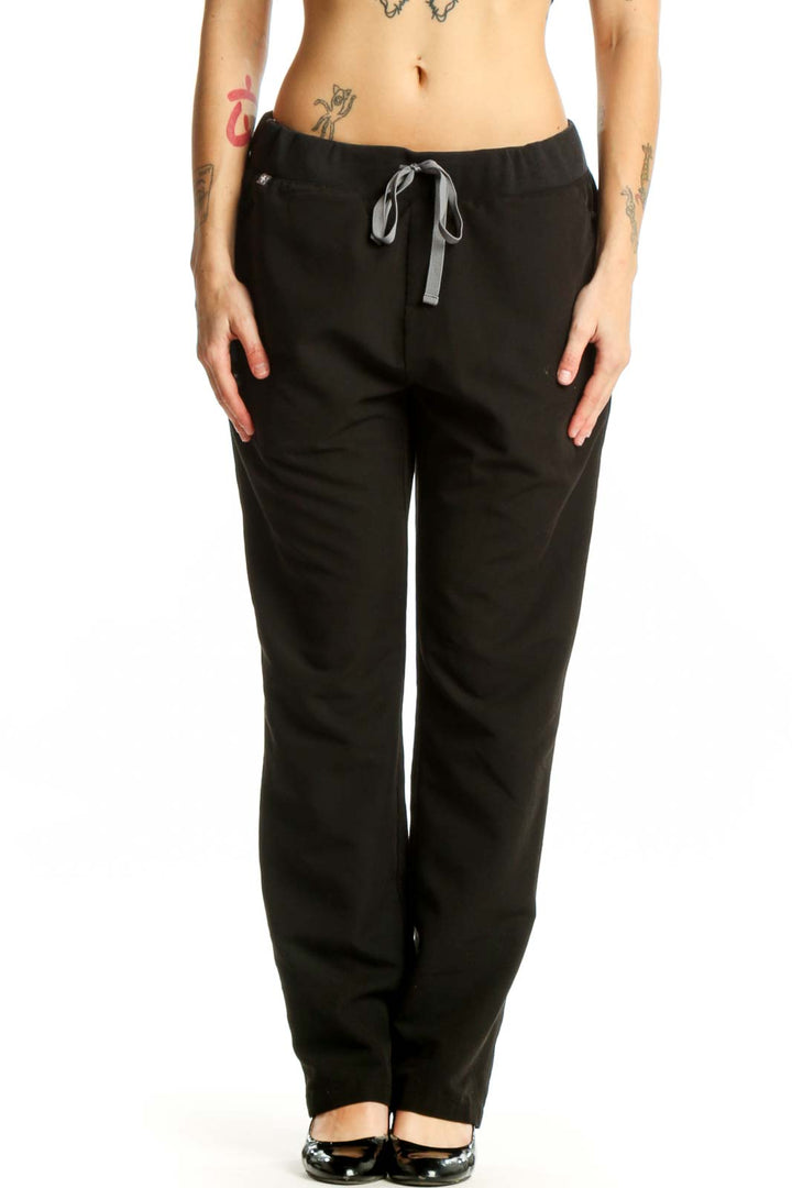 FIGS Black Drawstring Jogger Pants front view with tapered ankles and side pockets