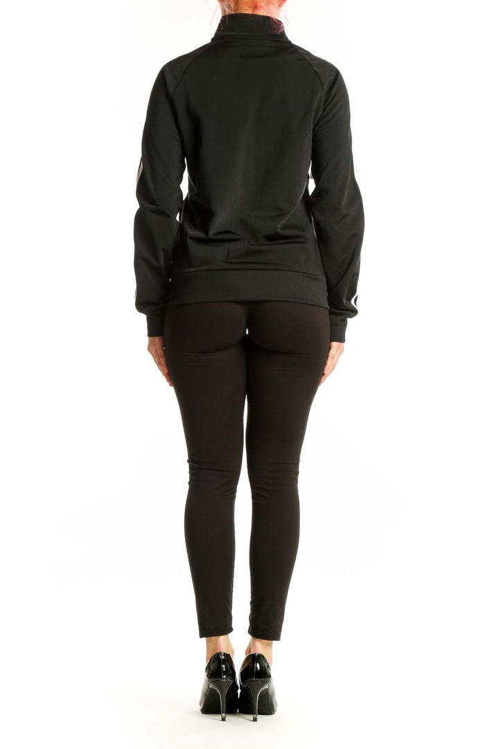 Black Adidas track jacket with white three stripes, back view on model