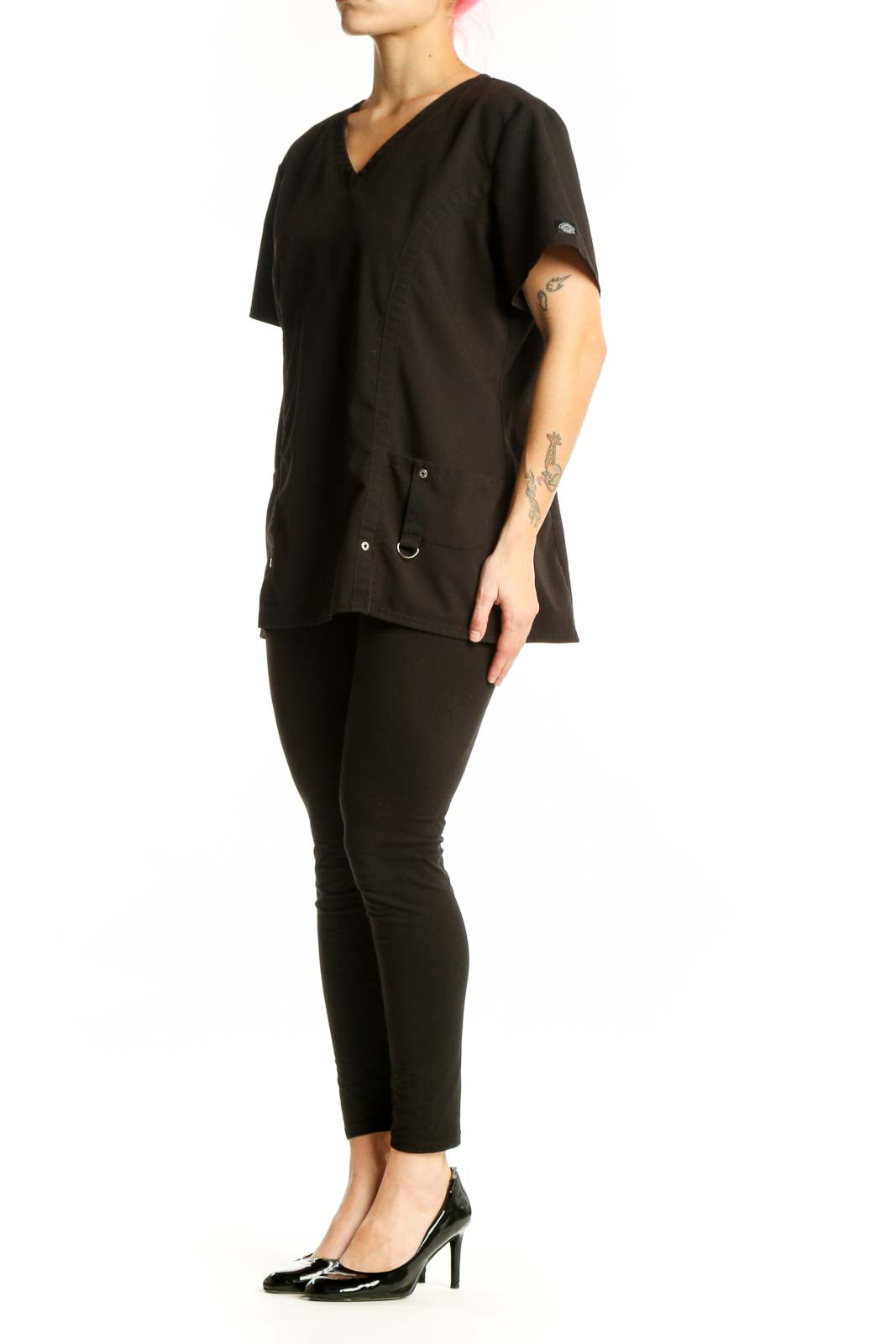 Black V-Neck Medical Scrub Top by Dickies with side pockets and drawstring details, front view on model