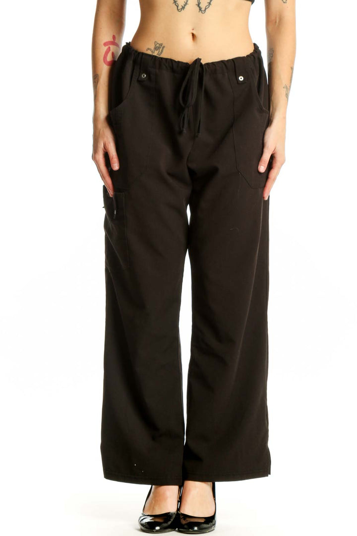Black cargo pants with drawstring waist and side pockets, front view on model