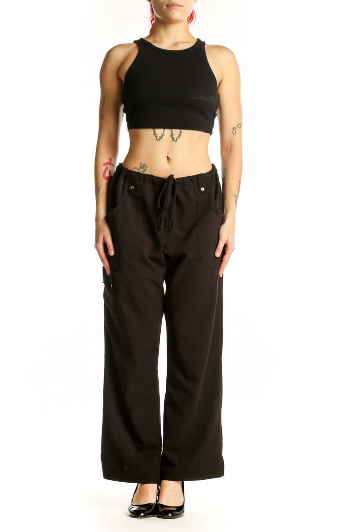 Black cargo pants with drawstring waist and side pockets, front view on model