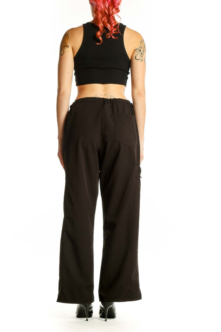 Black cargo pants with drawstring waist, back view on model showing relaxed fit