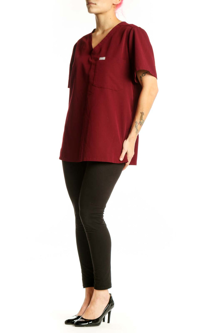 FIGS Burgundy V-Neck Medical Scrub Top front view, size L, featuring chest pocket and short sleeves