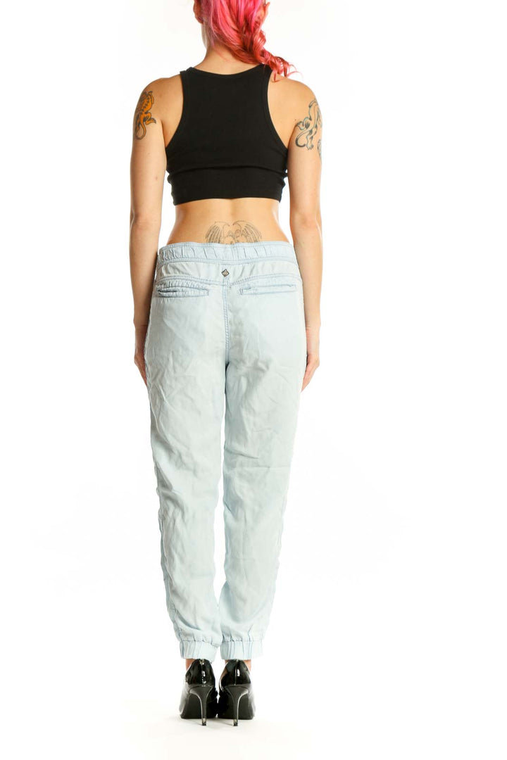 Back view of light blue Tencel cargo jogger pants showing tapered ankle cuffs and relaxed fit silhouette