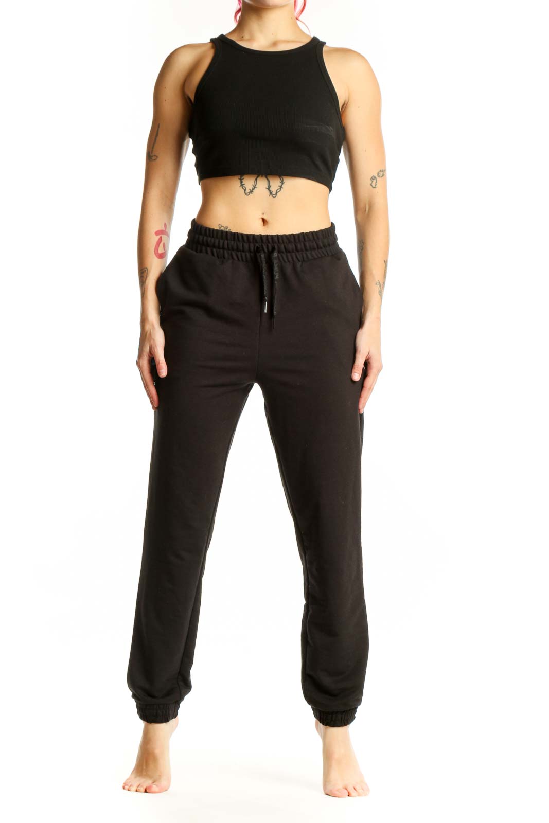 Black Puma jogger sweatpants with drawstring waistband and tapered ankles, front view on model